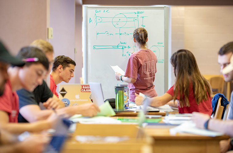 group of students study together in a residence hall community room