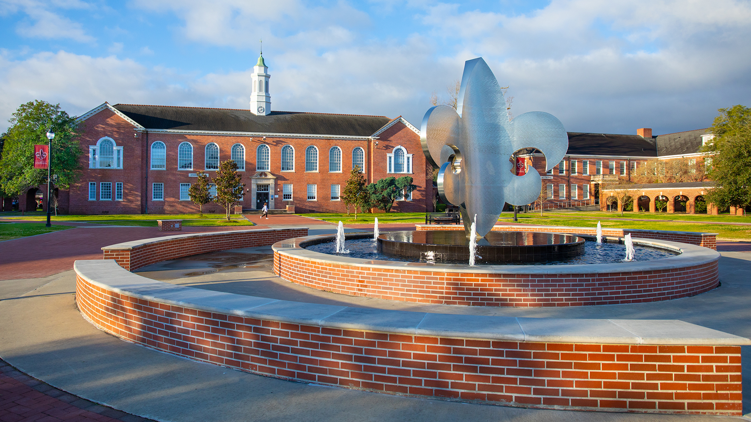 The University of Louisiana at Lafayette Quad with the fleur de lis fountain in the foreground and Stephens Hall bell tower in the background