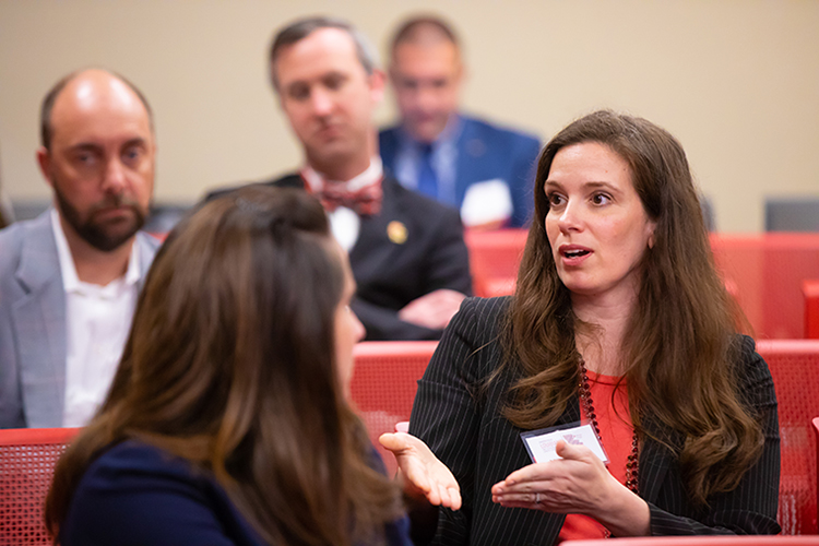 UL Lafayette faculty and staff engage in conversation at a conference