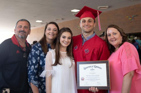 A University of Louisiana at Lafayette graduate and his family at commencement