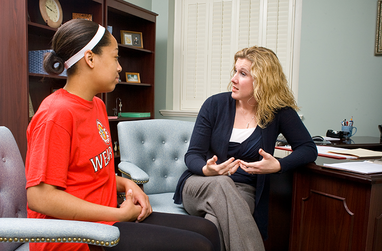 counselor and student sitting in office