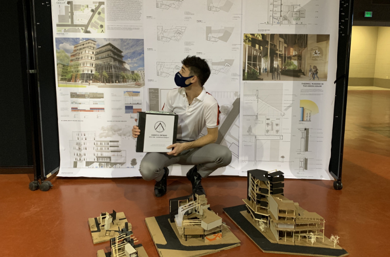 Adam Ortego sits with his comprehensive project that he made for his architecture major at UL Lafayette.
