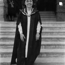 Old photo of a older woman wearing graduation attire
