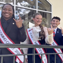 Three UL homecoming court members throw up the UL sign
